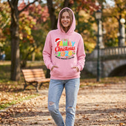 A pink pullover hoodie laid flat on a dark surface, featuring a colorful 'Family Christmas 2026' graphic with a Santa hat and the phrase 'Making Memories Together' on the front.