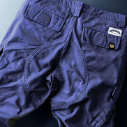 Navy blue cargo pants shown flat from the back.