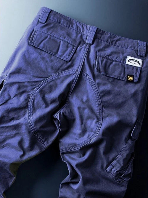 Navy blue cargo pants shown flat from the back.