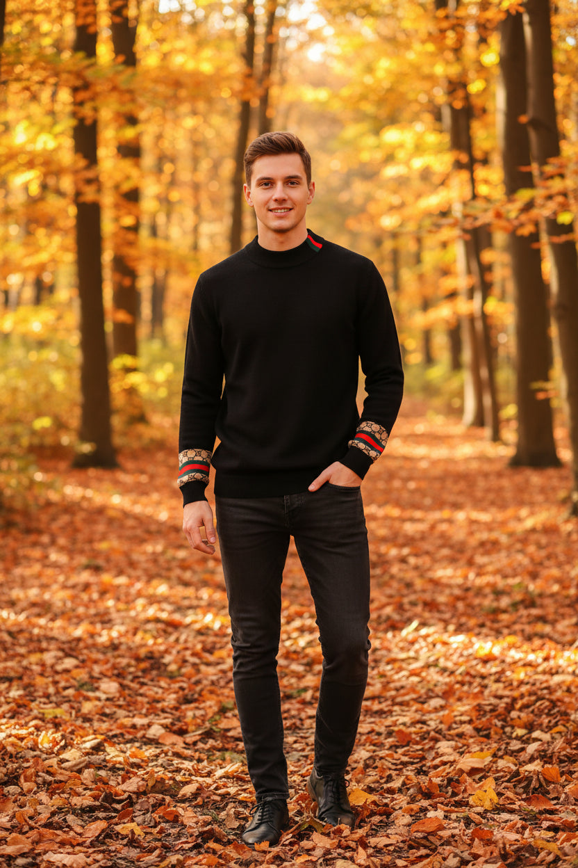 Black sweater with a hanger on a gray background