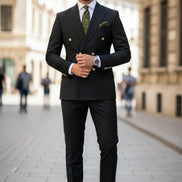 Black suit jacket with gold buttons and matching pants on a white background