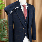 Navy checkered suit on a mannequin against a beige curtain background