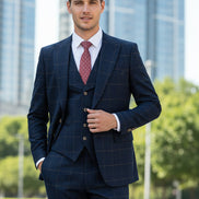 Navy checkered suit on a mannequin against a beige curtain background
