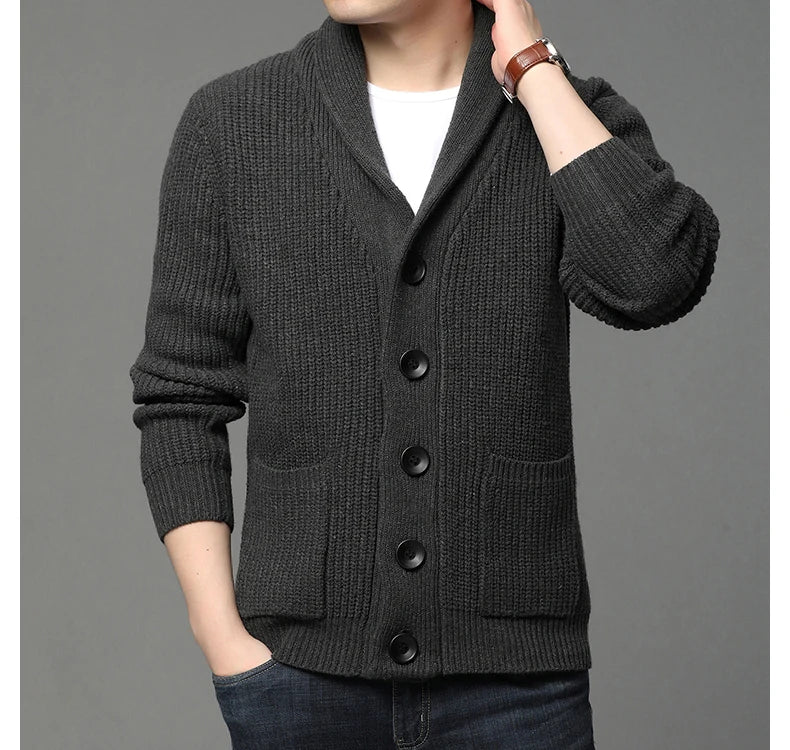 Dark gray cardigan worn by a person on a gray background