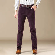 Person wearing purple corduroy pants with a plain background