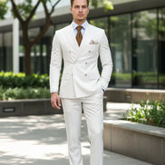 White suit jacket with a brown tie and pocket square on a dark background
