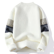 White sweater with patterned sleeves on a white background