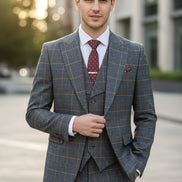 Blue checkered suit on a mannequin with a brown curtain background