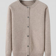 A light beige knit cardigan sweater with a crew neck and front button closure, hanging on a dark wooden hanger against a solid gray background.