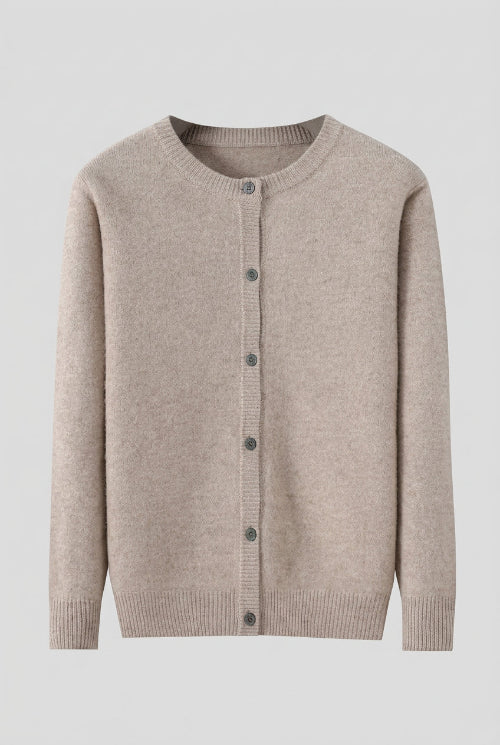 A light beige knit cardigan sweater with a crew neck and front button closure, hanging on a dark wooden hanger against a solid gray background.