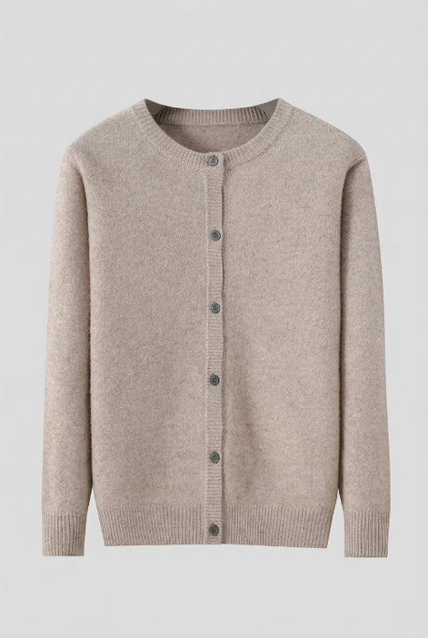 A light beige knit cardigan sweater with a crew neck and front button closure, hanging on a dark wooden hanger against a solid gray background.