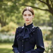 Black blouse with ruffled details on a white background