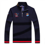 Navy blue long-sleeve shirt with embroidered logos on a white background