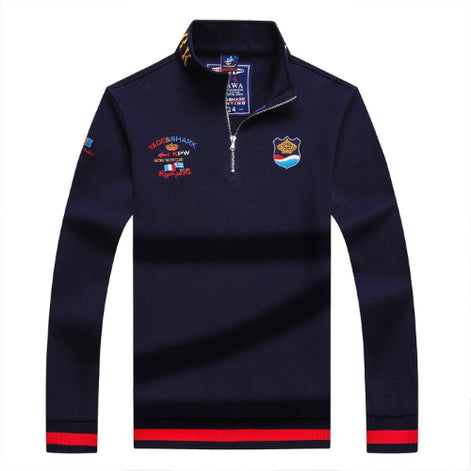Navy blue long-sleeve shirt with embroidered logos on a white background