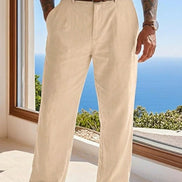 Person wearing beige pants with a scenic view of the ocean through a window.