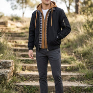 A men's black hooded jacket with tan fleece lining, a tan quilted interior, and a plaid patterned inner placket, shown on a white background.