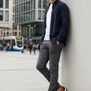 Pair of brown leather shoes with black toe caps on a light gray background