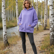Purple hoodie worn by a person on a white background