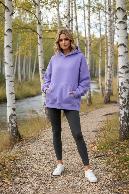 Purple hoodie worn by a person on a white background