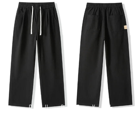 Front and back views of black straight-leg pants laid flat, showing an elastic waistband, white drawstring, slanted side pockets, and back patch pockets.