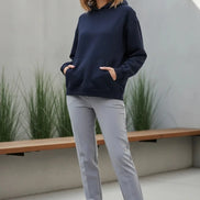 Navy blue hoodie worn by a person on a white background