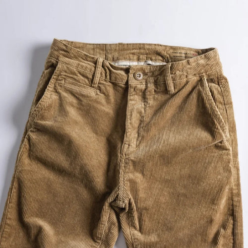 A pair of brown corduroy pants laid flat against a light gray background.