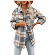 Woman wearing a gray and cream plaid shirt with tan accents and jeans.