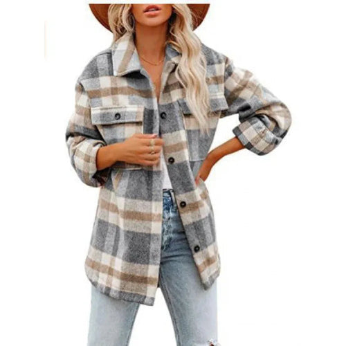 Woman wearing a gray and cream plaid shirt with tan accents and jeans.