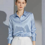 Light blue satin blouse worn by a model, shown from the front.