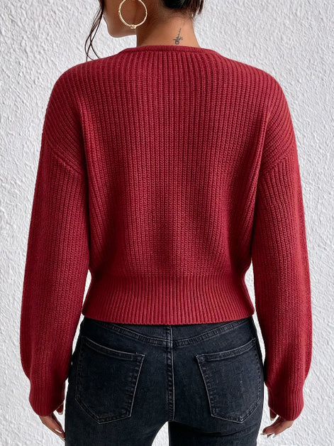 A person shown from the back wearing a ribbed knit long-sleeve sweater in a deep red or burgundy tone, 