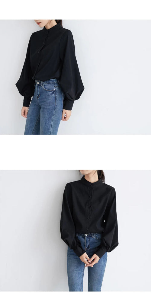 Person wearing a black blouse and blue jeans against a white background