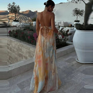Woman in a colorful dress standing on a patio with scenic views