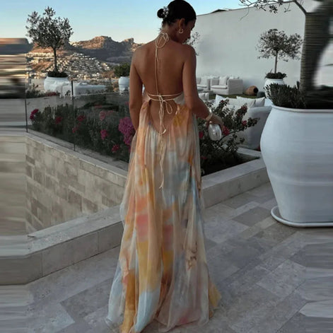 Woman in a colorful dress standing on a patio with scenic views