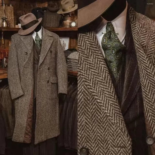 Brown herringbone coat with matching hat and tie on a mannequin against a rustic background.