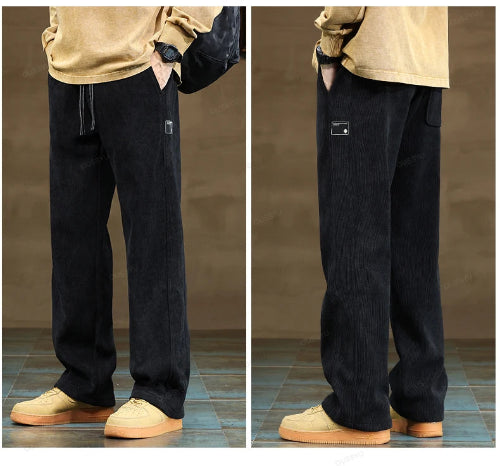 Black pants worn by a person on a brown floor.