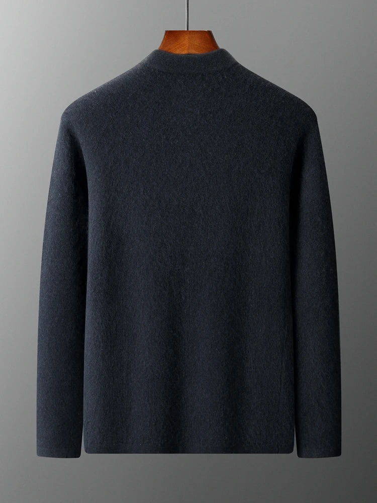 Dark gray sweater on a wooden mannequin against a gray background