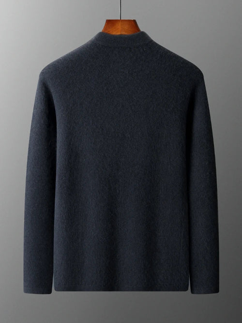 Dark gray sweater on a wooden mannequin against a gray background