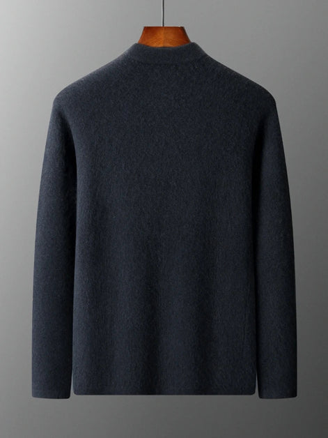 Dark gray sweater on a wooden mannequin against a gray background