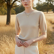 Beige knit top worn by a mannequin against a neutral background