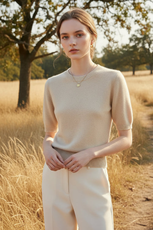 Beige knit top worn by a mannequin against a neutral background