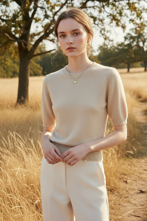 Beige knit top worn by a mannequin against a neutral background