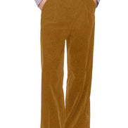 A person wearing high-waisted, wide-leg brown corduroy trousers, styled with a light purple ruffled blouse and black shoes, 