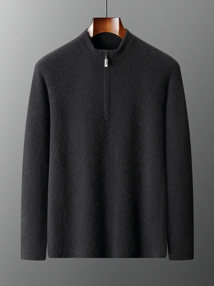 Dark gray sweater on a hanger against a gray background