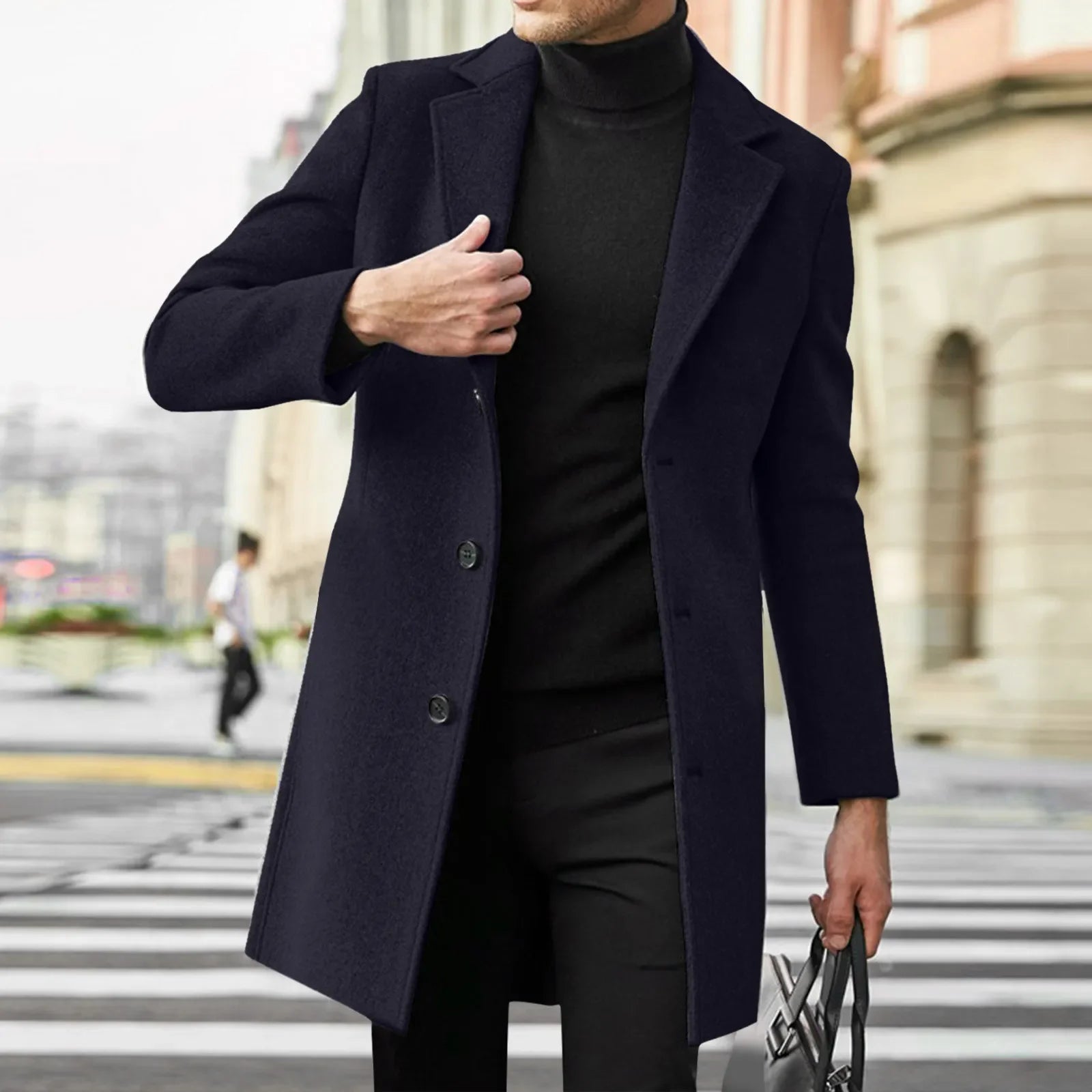 Man wearing a dark coat and black outfit crossing a street.