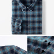 A folded plaid button-up shirt in blue and navy tones, shown on a clean white background with two detail inset panels at the bottom highlighting the fabric texture, buttons, and collar.
