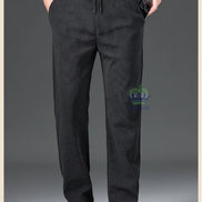 Black pants worn by a person on a gray background