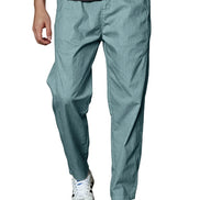 A person wearing teal-blue relaxed-fit pants with a dark gray ribbed t-shirt and white sneakers, shown from the waist down against a plain white background.