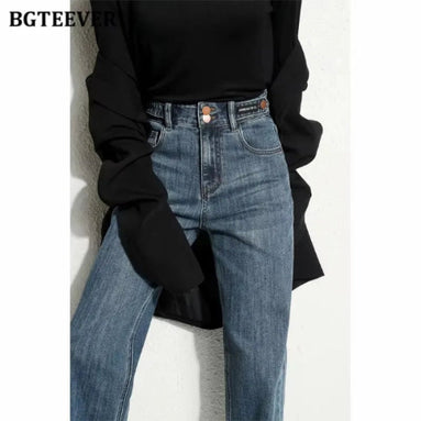 A model wearing high-waisted, wide-leg blue denim jeans with a black long-sleeve 