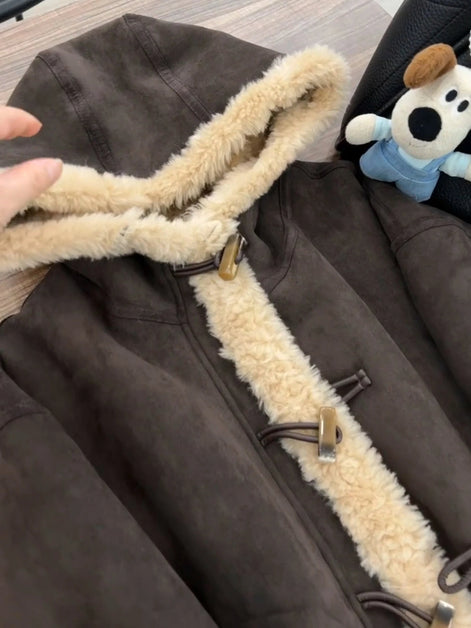 Close-up of a brown hooded jacket showing cream fleece-look trim around the hood and front with toggle fastenings