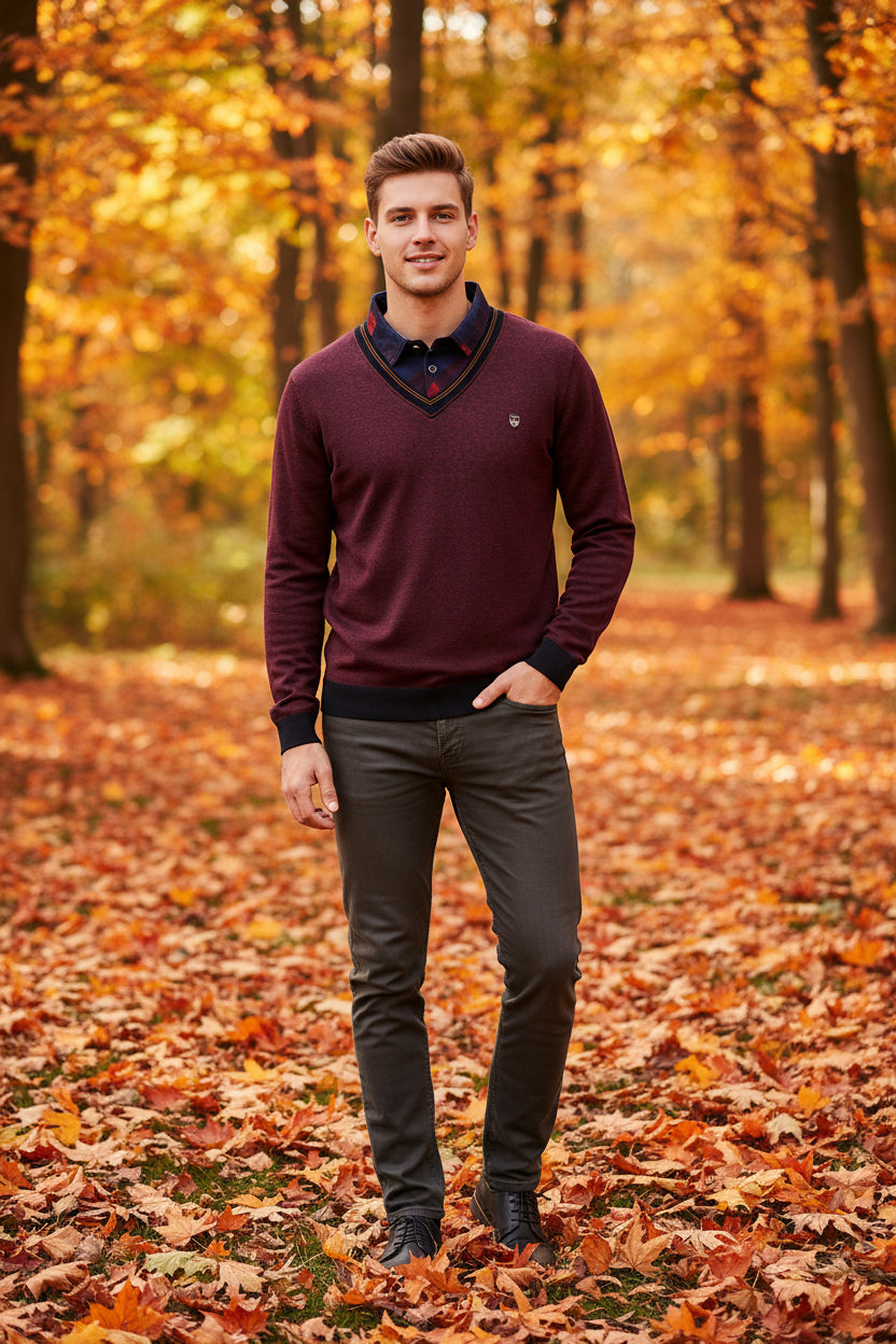 Maroon sweater with navy collar and trim on a white background